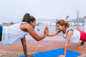 2 healthy happy women doing yoga