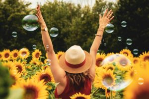 Healthy happy lady in a Sunflower field